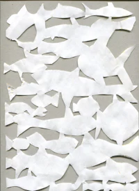 a white piece of paper with fish cut out of it