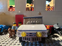 lego minifigures in a room with a toy car