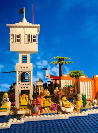 a group of people on a beach with a lifeguard tower