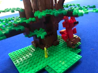 a lego model of a tree with a red lego