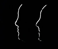 two silhouettes of a man and a woman on a black background
