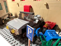 a lego model of a car and a truck in a parking lot